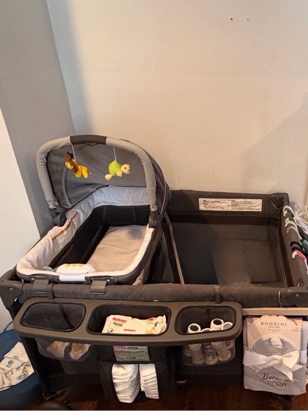 Gray Portable Baby Playard Organizer with Integrated Changing Bassinet